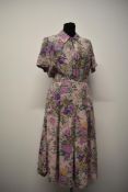 A 1940s silk day dress, having palest pink ground with amazing orchid pattern in various shades of
