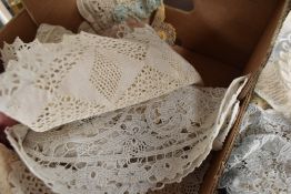 A mass of vintage and antique doyleys, including intricate worked lace and crochet examples.