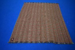 A vintage Dartington Hall rug, woven by Dartington Tweeds, Totnes, Devon, England.