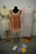 Three pairs of vintage pastel coloured stockings, two nylon nightdresses and a lace underskirt