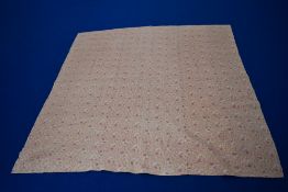An early 20th century pink floral hand stitched quilt, having bold rose pattern to front and plain
