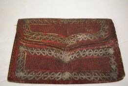 A 1771 dated oxblood couloured leather Ottoman wallet, with white metal embroidery and '