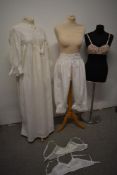 An Edwardian nightdress, a pair of split leg bloomers, a pink satin and lace 1930s/40s bra and two