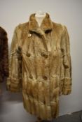 A vintage 1960s coney coat and a similar cape, around 1940s.