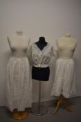 An early 20th century corset cover, a petticoat with pin tucks and embroidery to hem and a pair of