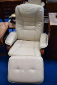 A cream leather easy chair and footstool (distressed)