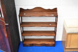 A reproduction Regency style wall shelf having three drawers