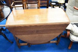 An early 20th Century light oak gate leg dining table