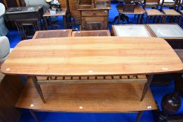 A vintage coffee table having polished top and slatted undertier, approx 137 x 50cm