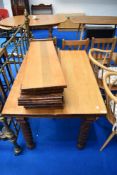 A 19th Century extending dining table with several leaves and centre leg support
