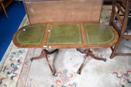 A reproduction Regency part leather topped coffee table