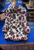A 19th Century easy chair having walnut knurl frame and later upholstery