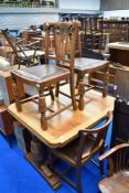An early 20th Century oak drawer leaf dining table on bulbous frae and a set of four similar chairs