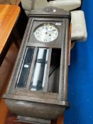 An early 20th Century oak cased wall clock