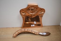An Art Nouveau copper crumb tray and copper clad brush, with embossed decoration, registration