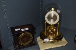 A mid century mantel clock and a small oak Smiths clock with brass face and Roman numerals.