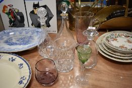 Three decanters, a pink tinged water jug, a cut glass jug, a pink tinged vase with etched floral