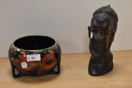 An early to mid 20th century Moorcroft bowl sat over three feet, having tube lined fruit design to