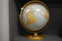 A vintage globe on metal stand.