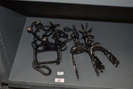 A set of vintage spurs and two stirrups, not a pair.