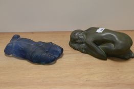 An Art nouveau style paperweight in green depicting sleeping maiden and another of blue glass,