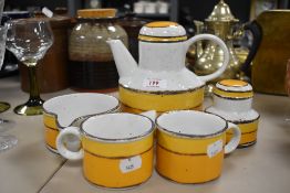 A vibrant mid century mid winter coffee pot, sugar basin, soup dish and two mugs.