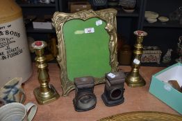 A large vintage brass photo frame having moulded Art Nouveau style decoration depicting a maiden