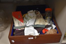 A mahogany box filled with as selection of mixed modern and vintage haberdashery.