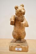 A carved wood black forest style bear.
