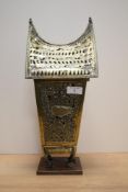 An early 20th century pagoda, having bird and elephant decoration, mounted on wooden stand, possibly