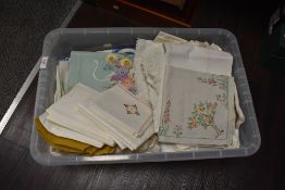 A collection of vintage and antique table linen, including damask, embroidered examples and deep