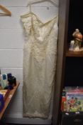 A 1980s off the shoulder beaded wedding dress.