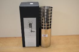 A Georg Jensen matrix collection tube vase of glass and stainless steel.