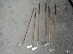 Six early 20th century Hickory Shafted Golf Irons and Putters, C'Ochranes Ltd Edinburgh Mid Iron,