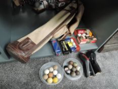 A collection of vintage Golf Accessories including canvas bag, leather woods covers, Balls including