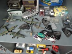 A shelf of modern diecasts including Oxford, Atlas, Leyuan and similar, Cars and Aeroplanes, some