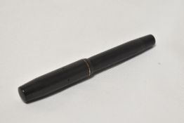 A Mentmore Auto-Flow button fill fountain pen in black with engine turn design single narrow band to