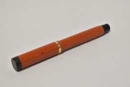 A Parker Duofold Lucky Curve Snr button fill fountain pen in red with single broad band to the cap