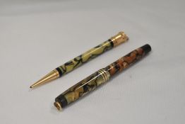 A Parker Duofold Lady Moderne button fountain pen in pearl and black with three bands to ring cap