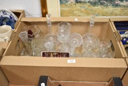 A carton of glass ware, including two decanters, sundae dishes, vinegar bottles, glasses and vases