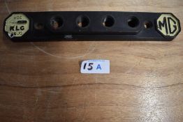 A vintage Bakelite KLG MG spark plug display stand.