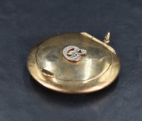 A 9ct gold and diamond chip set powder compact, of circular form the hinged cover with diamond