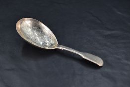 A Victorian silver fiddle pattern caddy spoon, the oval bowl with foliate bright-cut engraving,
