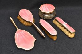 A George V pink guilloche enamelled silver-mounted four-piece dressing table set, comprising hand
