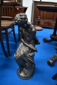 A bronzed resin figure of demi clad classical maiden or godess sat on rock, after Mathurin Moreau