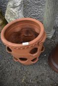 A terracotta strawberry planter