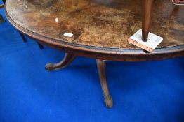 A Victorian oval table having quarter veneered walnut top on turned column, quadrupl shaped legs and