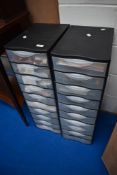 Two banks of plastic storage drawers containing a selection of crafting and card making equipment