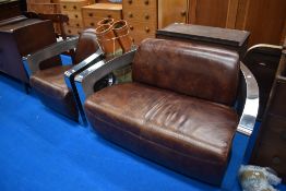 An Art Deco inspired leather settee and armchair with chrome frame