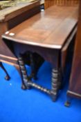 A period oak drop leaf dining table having turned gate legs